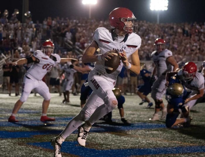 2025 5-star QB George MacIntyre rolling right during a high school game on August 26th, 2023, in Nashville, Tennessee. (Photo by Denny Simmons of The Tennessean)